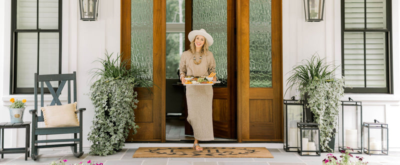 Eva Shockey stands before the open front for of her white house.