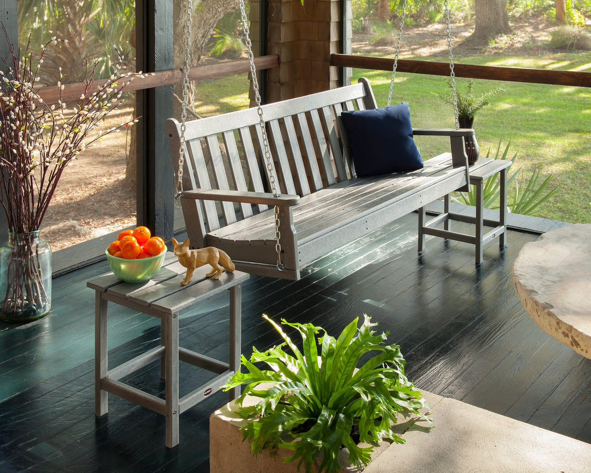 A POLYWOOD Vineyard 60 Inch Porch Swing in Slate Grey hangs on a screened porch.